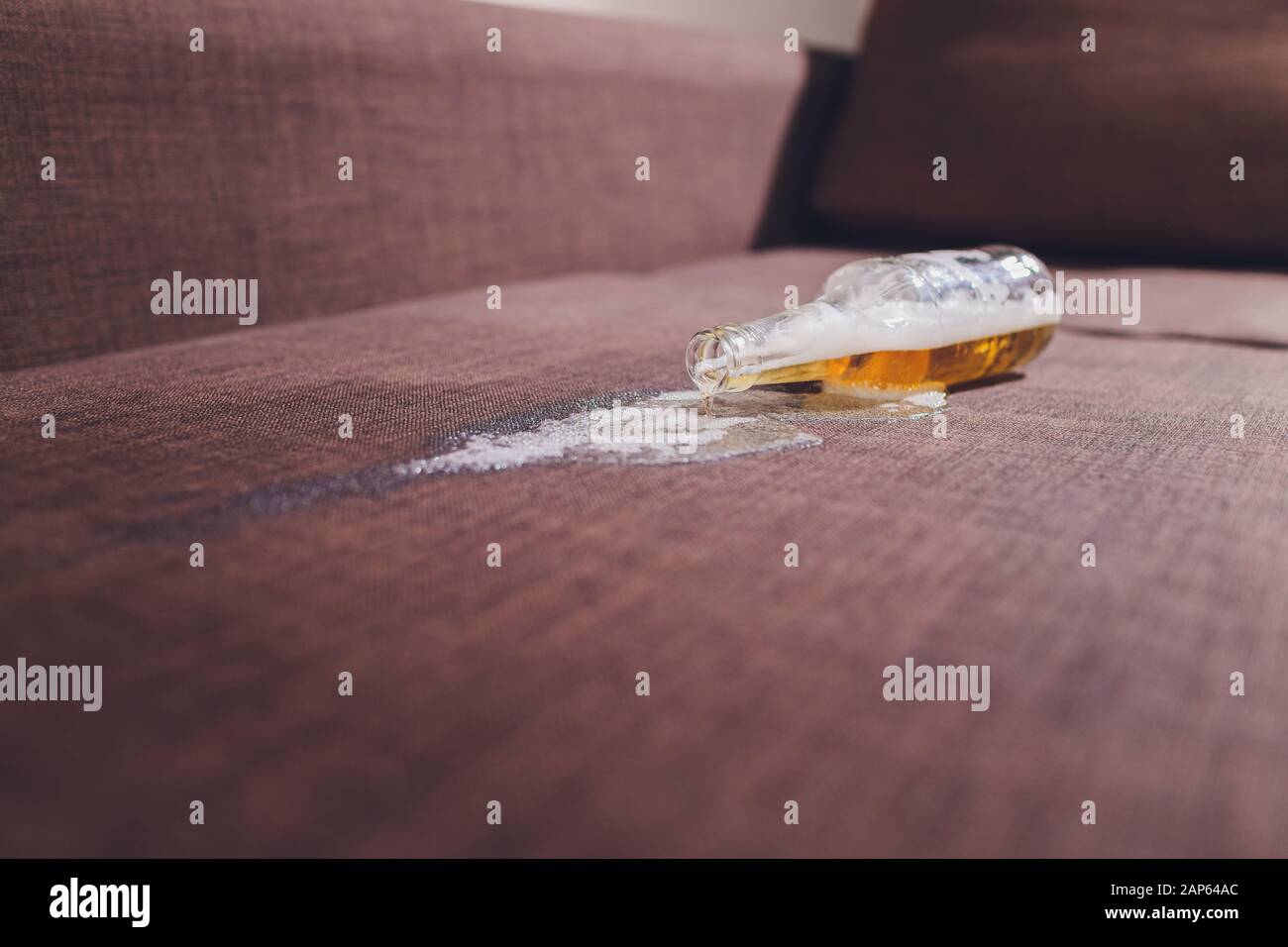 Alkoholismus in der Familie. Bierflasche und ausgelaufenes Bier auf dem  Sofa Stockfotografie - Alamy