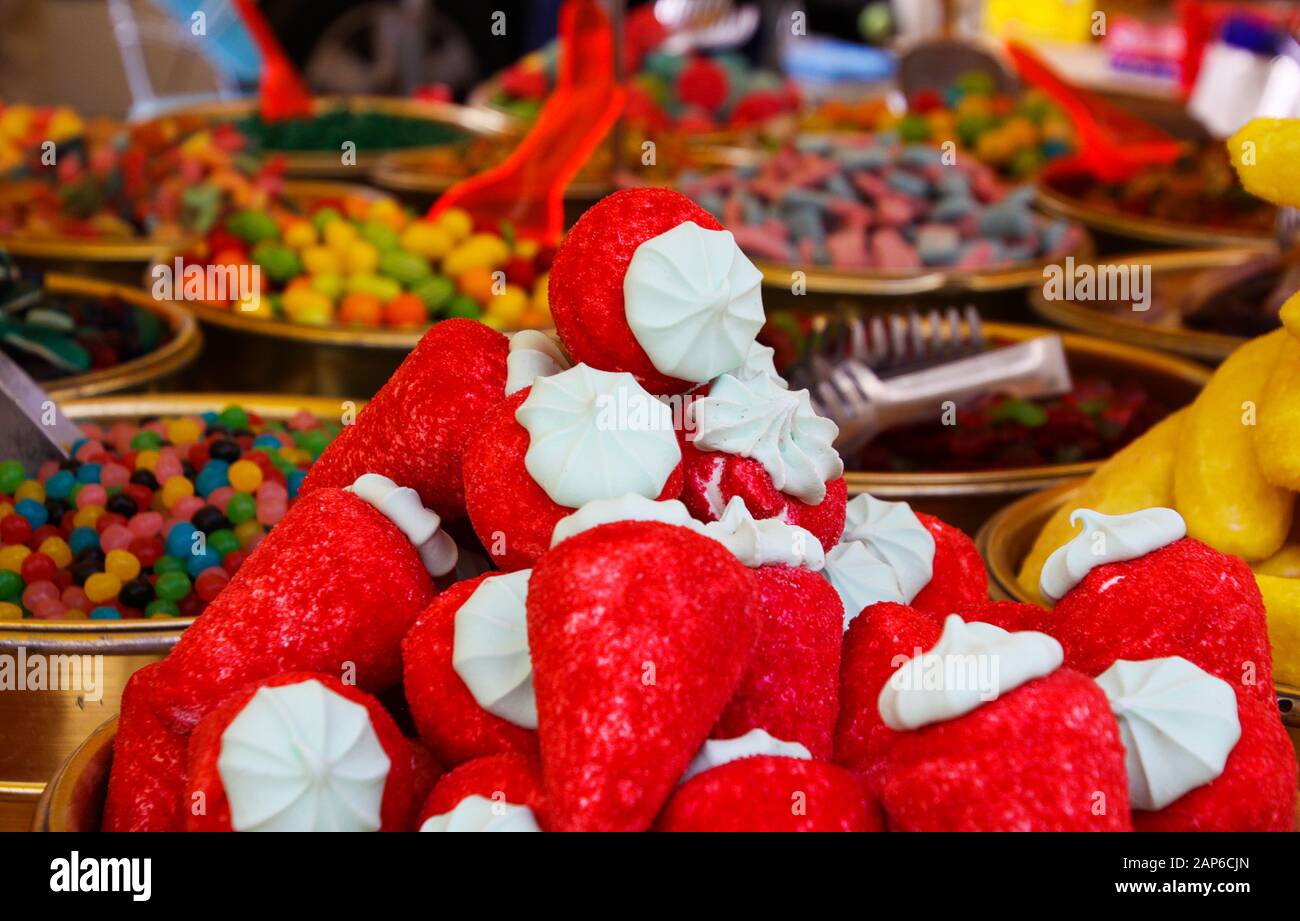 Nahaufnahme des Haufens von Süßigkeiten in Form von Erdbeeren mit verschwommenen Boweln, gefüllt mit Süßigkeiten auf dem französischen Markt - St. Tropez, Frankreich Stockfoto