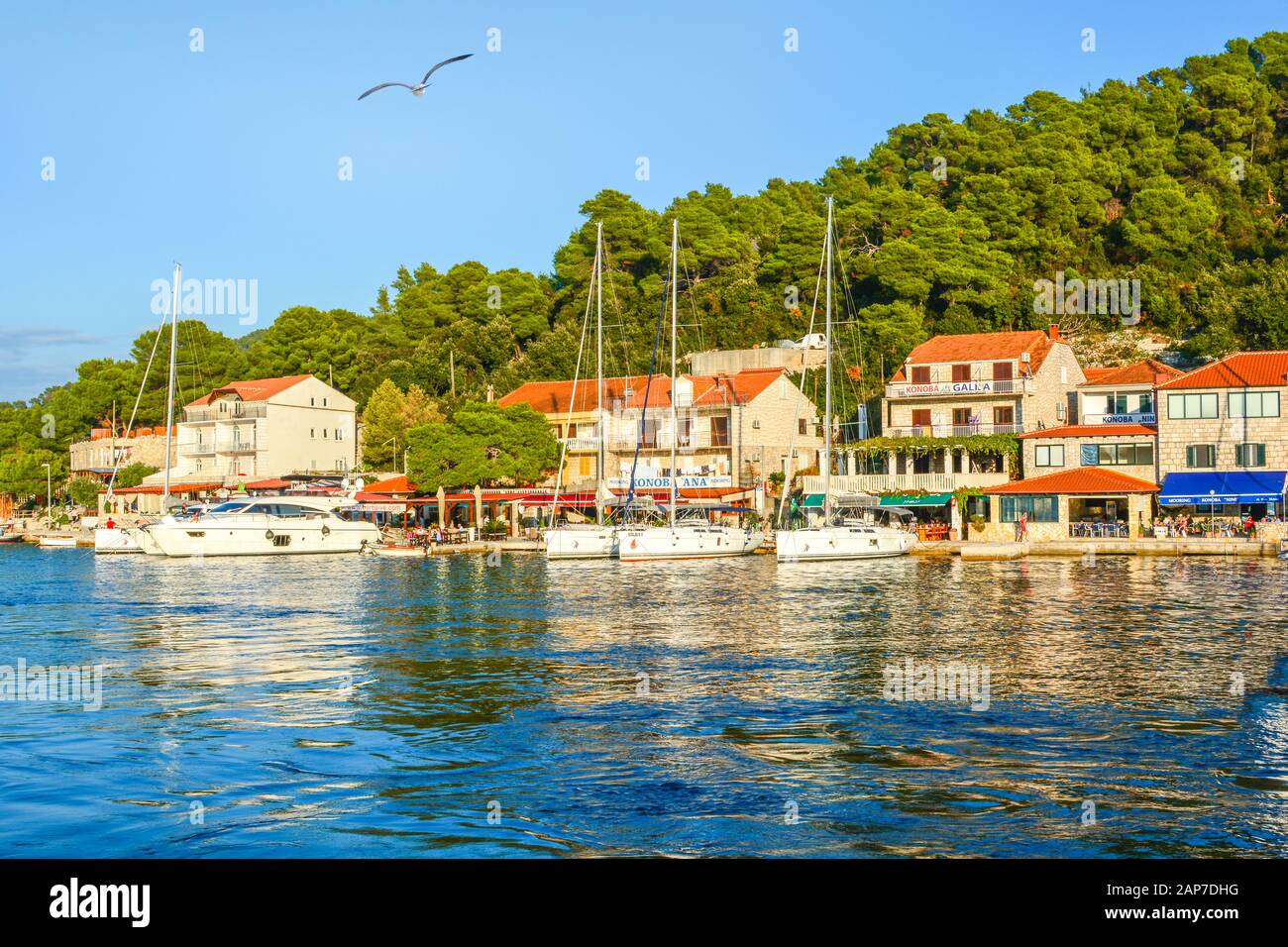 Boote dockten an einem sonnigen Tag im kleinen Hafen in einem malerischen Fischerdorf an der Küste Kroatiens in Dalmatien in der Nähe der Stadt Hvar an. Stockfoto