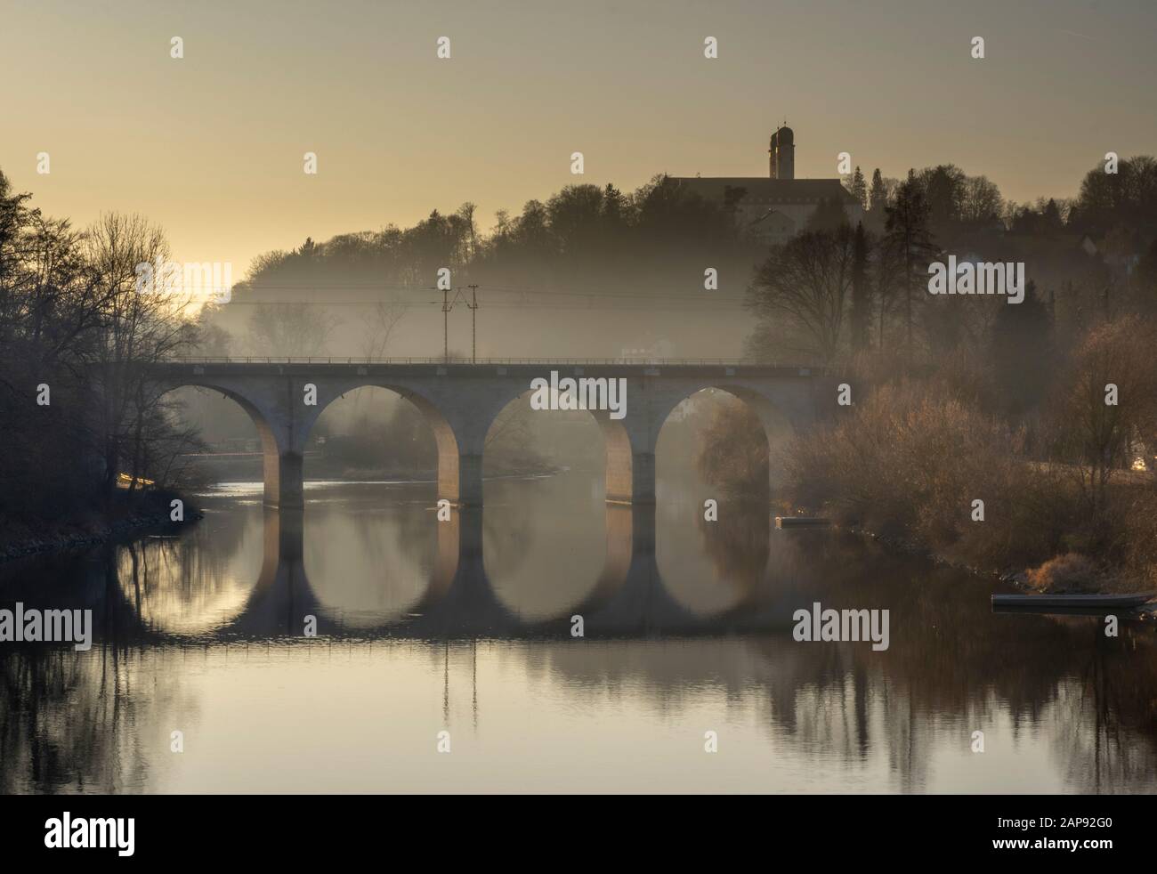 Alte Steinbrücke über den Fluss bei Sonnenuntergang im Herbst in bayern Stockfoto