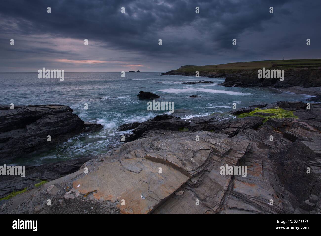Moody Skies an den felsigen Ufern der Boobys Bay Cornwall Uk Stockfoto