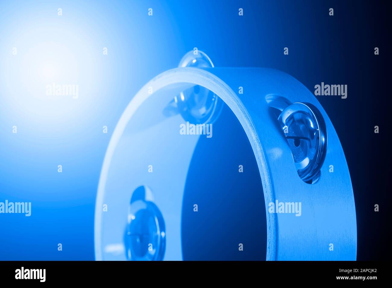 Tamburin isoliert auf schwarzem Hintergrund. Blauer Filter. Ein einziges Instrument für klassische Musik. Stockfoto