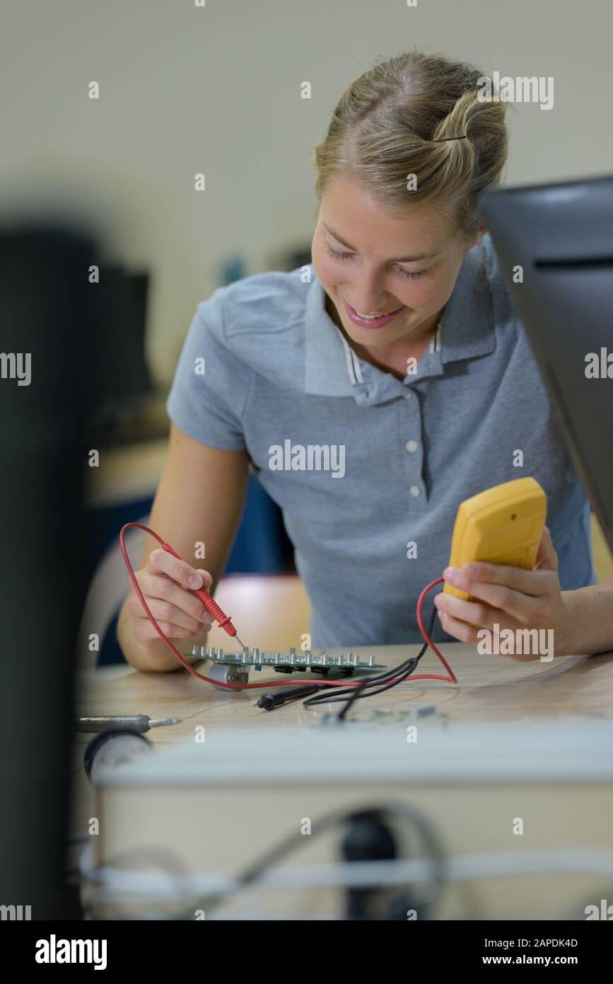 Laborassistentin repariert leiterplattenmodul für cnc-Robotik Stockfoto