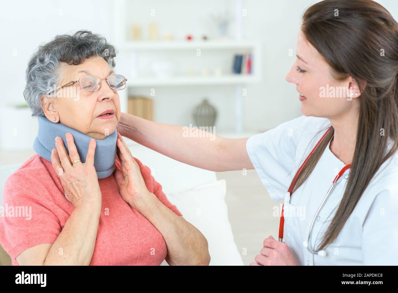 Arzt spricht mit einem leitenden Patienten mit Halsband Stockfoto