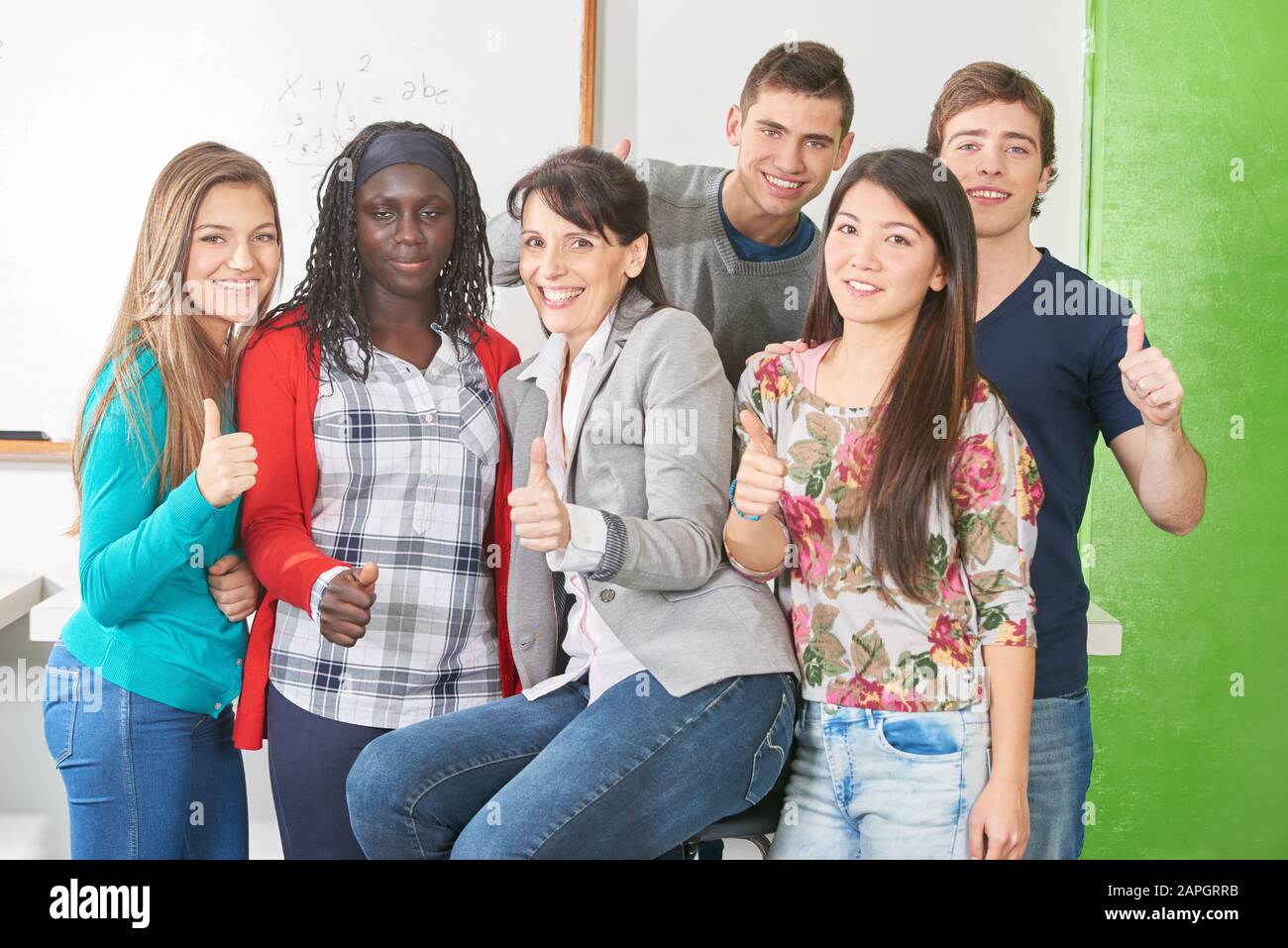 Schüler und Lehrer als Gruppe halten sich in der Schule die Finger gestreift Stockfoto