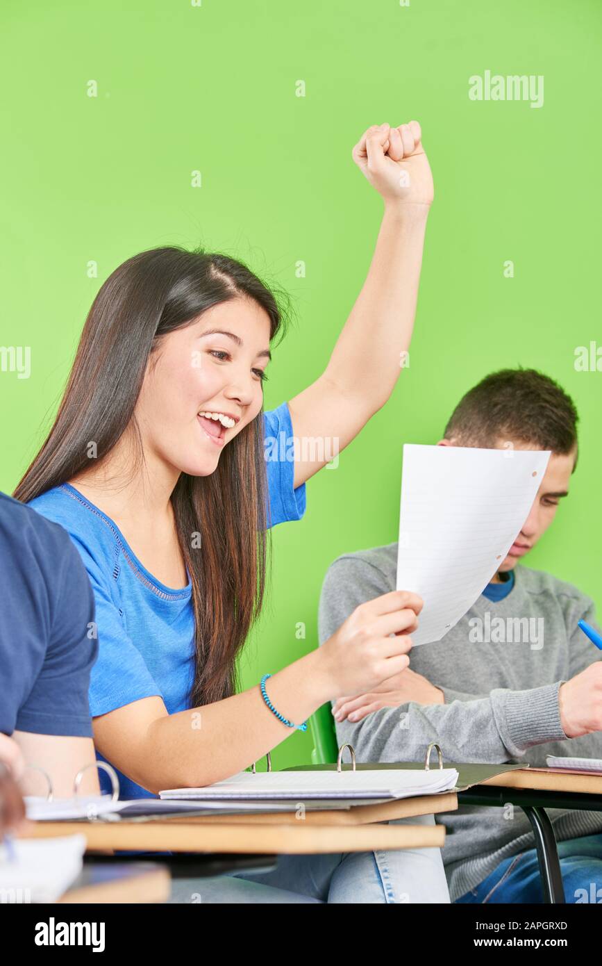 Asiatische Mädchen jubeln nach erfolgreicher Klassenarbeit glücklich in der Schule Stockfoto