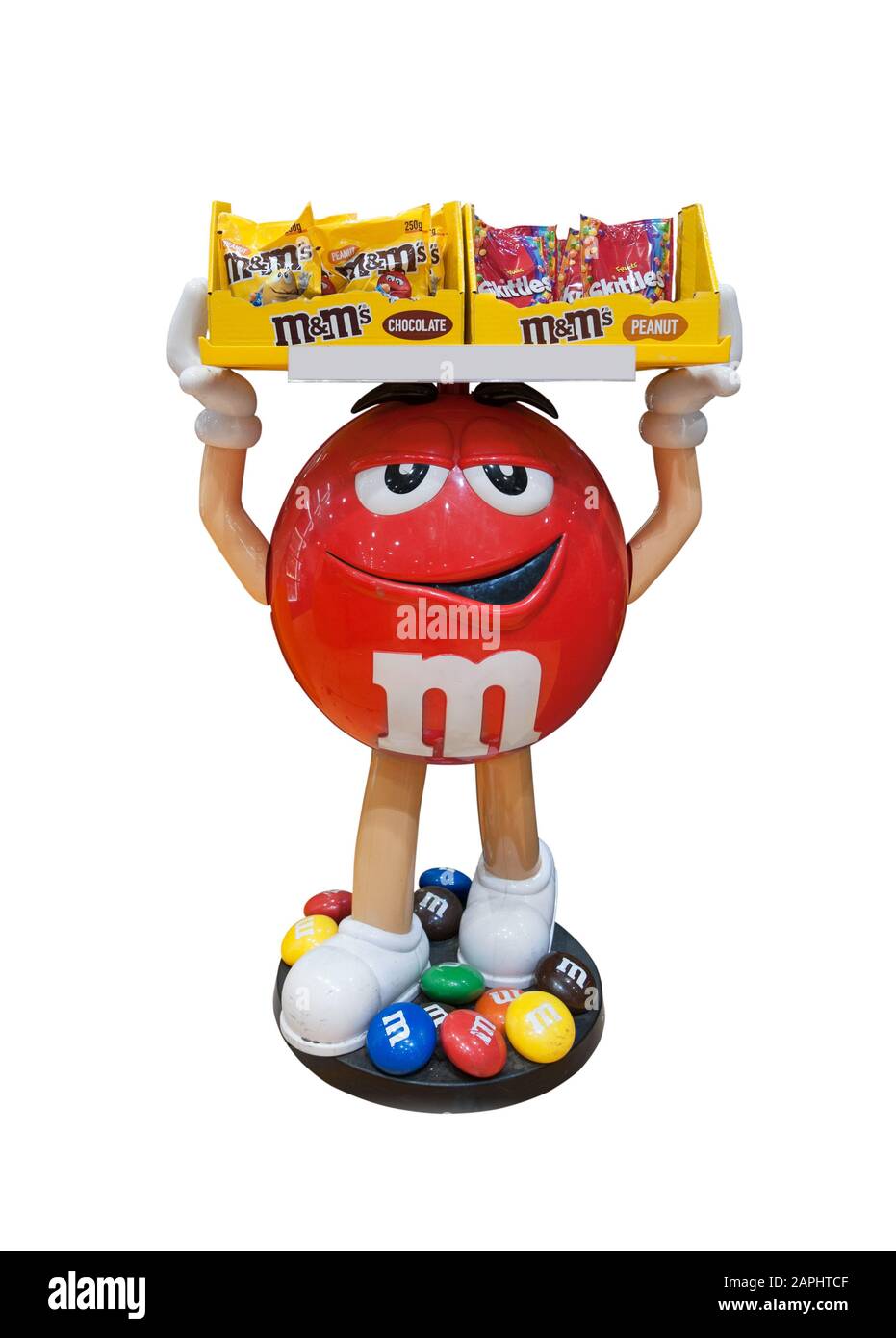 Florenz, Italien - 2020, 19. Januar: Roter M&M-Charakter hält einen Süßigkeiten-Container auf dem Kopf. Weißer Hintergrund. Beschneidungspfad. Stockfoto