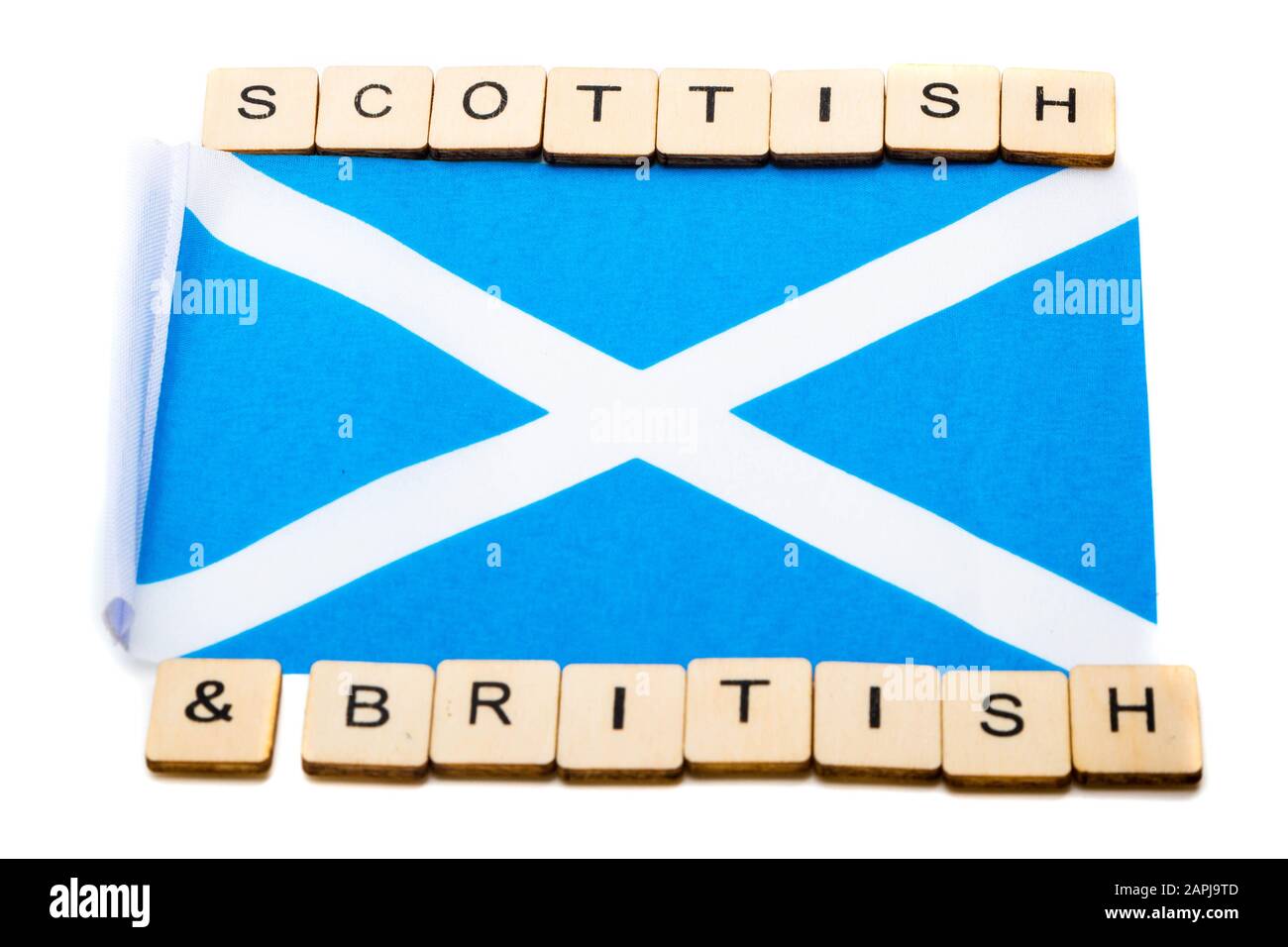Die Nationalflaggen Schottlands, der Saltaire oder das Kreuz von St Andrews auf weißem Hintergrund mit einem Schild, das schottisch-britisch liest Stockfoto