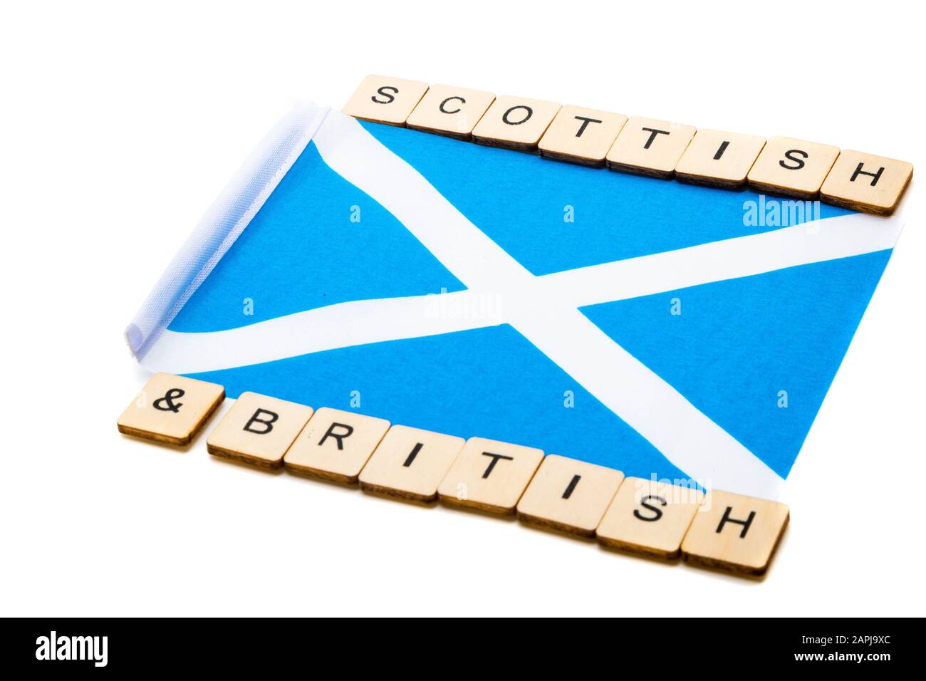 Die Nationalflaggen Schottlands, der Saltaire oder das Kreuz von St Andrews auf weißem Hintergrund mit einem Schild, das schottisch-britisch liest Stockfoto