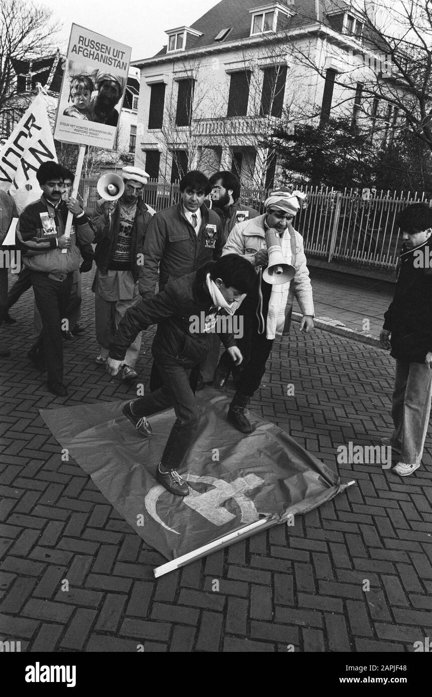 Afghanen demonstrierten in den Haag gegen russische Präsenz in Afghanistan Beschreibung: Demonstranten trampeln die sowjetischen Flaggen vor der afghanischen Botschaft Datum: 27. Dezember 1985 Ort: Den Haag, Zuid-Holland Schlüsselwörter: Botschaften, Demonstrationen, Demonstranten, Trampel, Flaggen Stockfoto