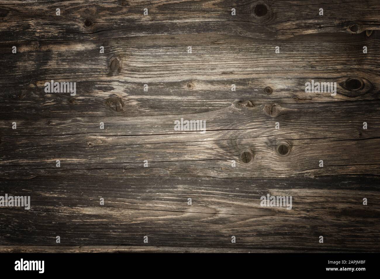 Dunkle Holzbohlen im Landhausstil mit lebendiger Textur und Vignettenbeleuchtung Stockfoto