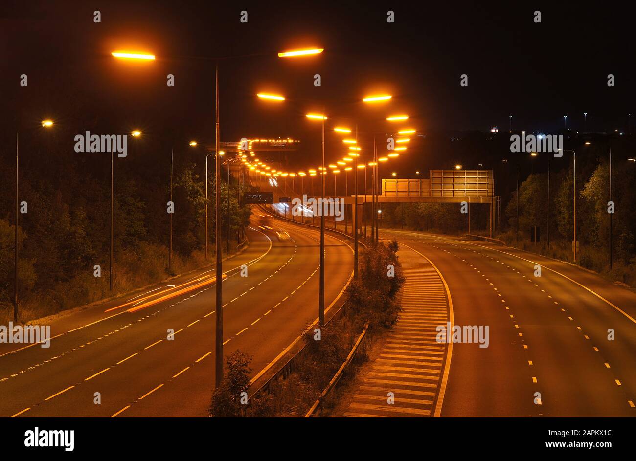 Niederdruck Natriumstraßenbeleuchtung auf einer englischen Autobahn. Wiederholung, Muster, Linie, Zeile. Straße in Großbritannien Stockfoto
