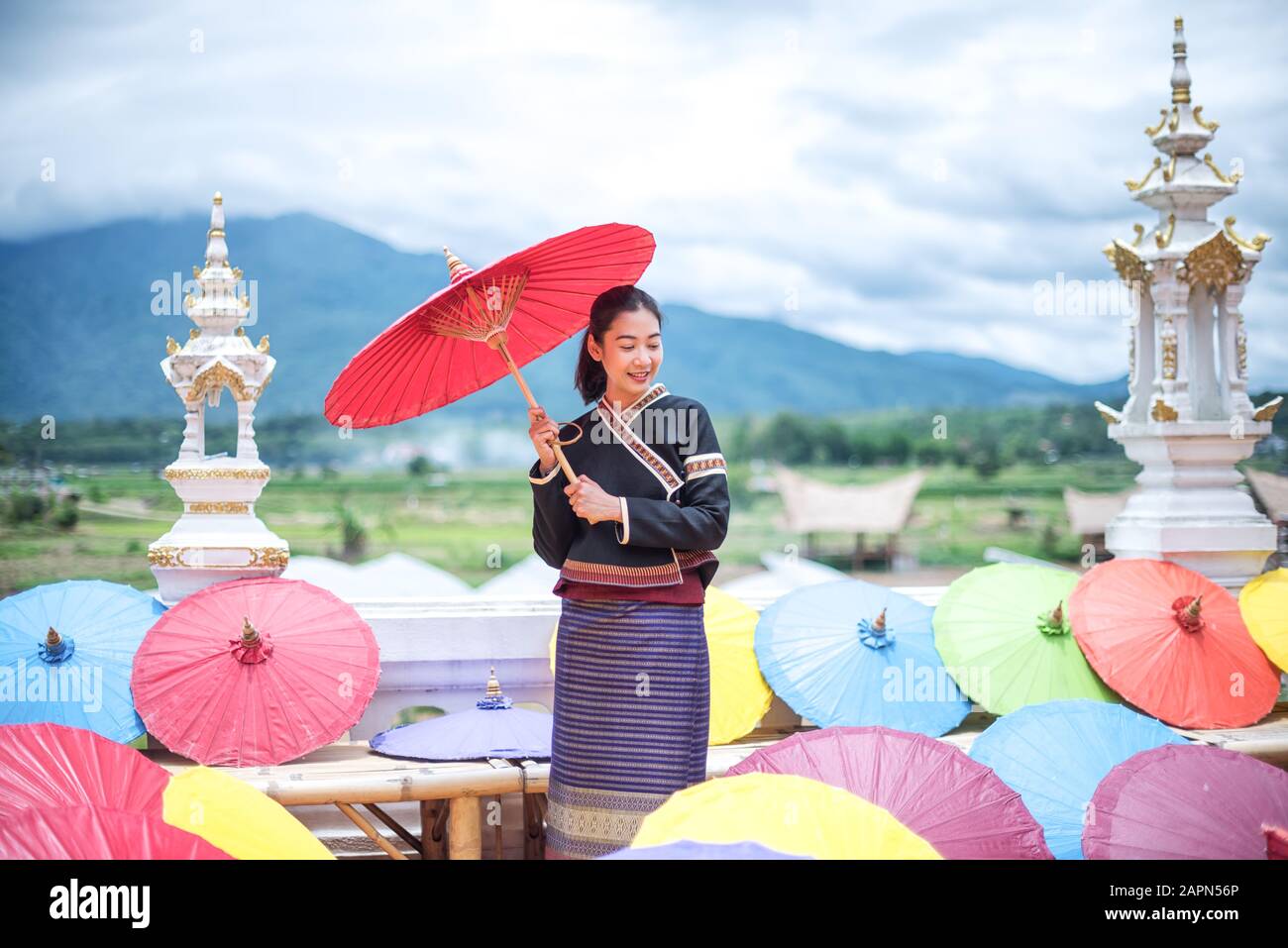 Porträt der Schönen thailändischen Frauen in Lanna Tracht, Handgefertigter Regenschirm, der Vintage-Stil in Thailand macht Stockfoto