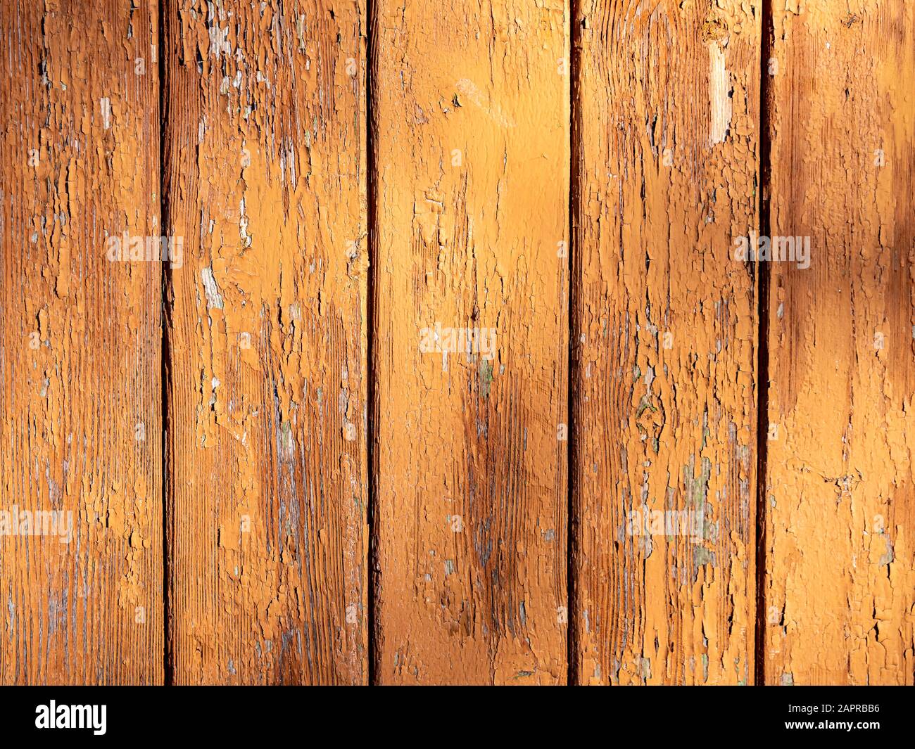 Orangefarbene Holzwand mit alter Farbe Stockfoto