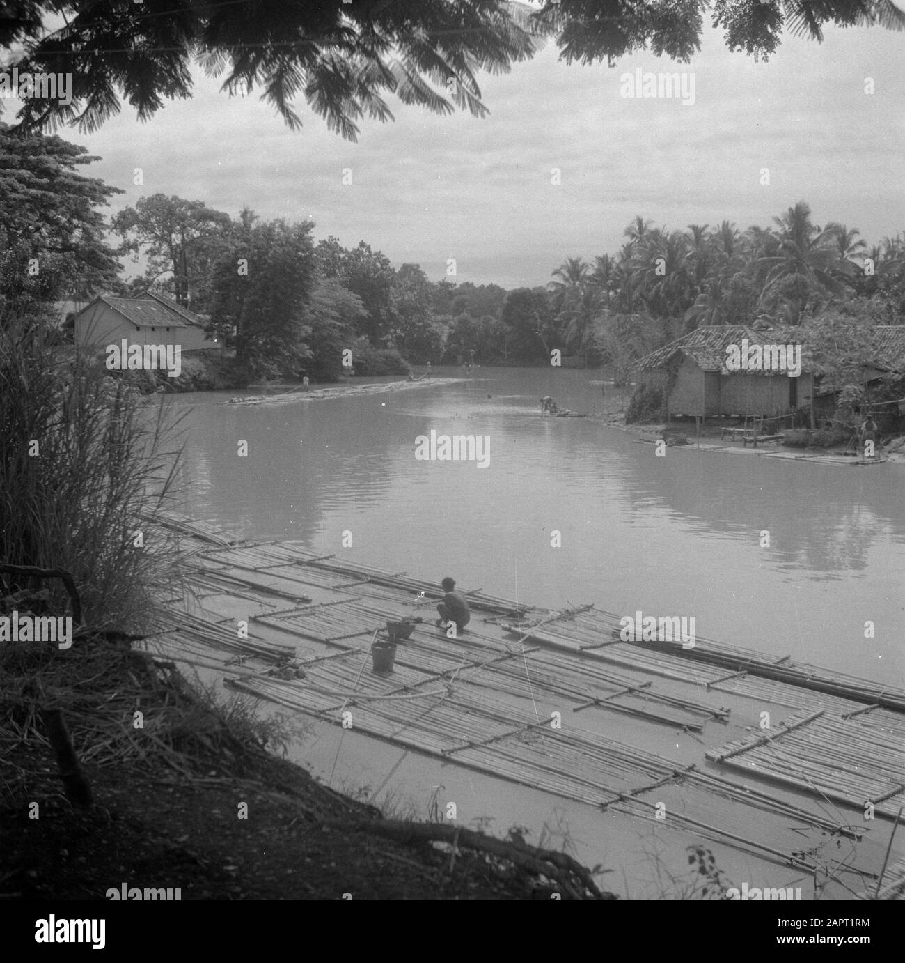 Reise nach Indonesien EINE Frau macht die Wäsche auf einer Bambusschleuse im Fluss Datum: 1946 Ort: Indonesien, Java, Niederländische Ostindien Schlüsselwörter: Bambus, Kampongs, Flöße, Frauen, Wäsche: Poll, Willem van de, Stockfoto