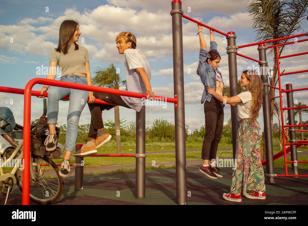 Vier Teenager haben Spaß in einem Outdoor-Fitnessstudio Stockfoto