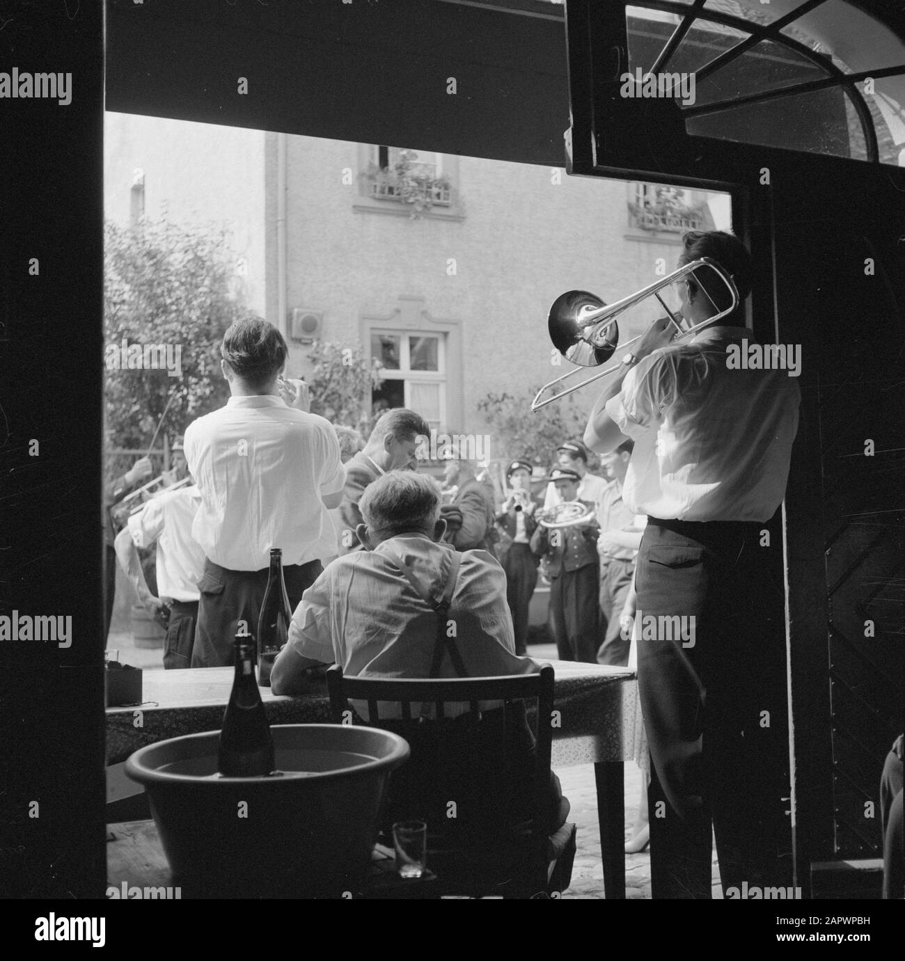 Mosel: Kostüm- und Weinfestmusiker am Eingang einer Winzerfirma Datum: 4. Juli 1959 Ort: Deutschland, Kröv, Rheinland-Pfalz, Westdeutschland Schlagwörter: Blasinstrumente, Musikis, Öffentlichkeit, Volksfeste, Wein, Weinkeller Stockfoto