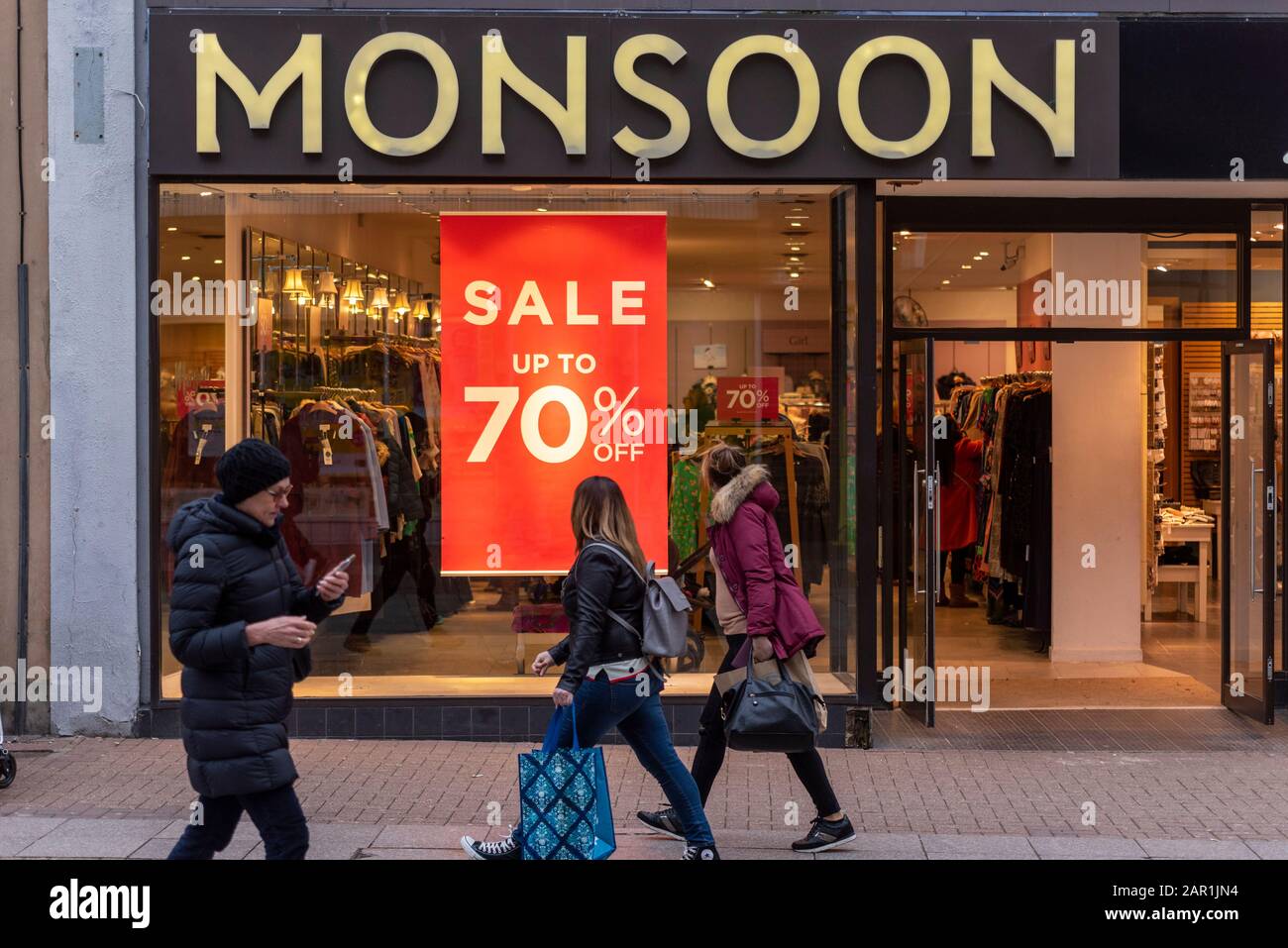 Monsun-Shop in Der High Street, Southend on Sea, Essex, Großbritannien mit Verkaufszeichen im Schaufenster. 70 %. Fensteranzeige im Modegeschäft. Menschen, die vergehen Stockfoto