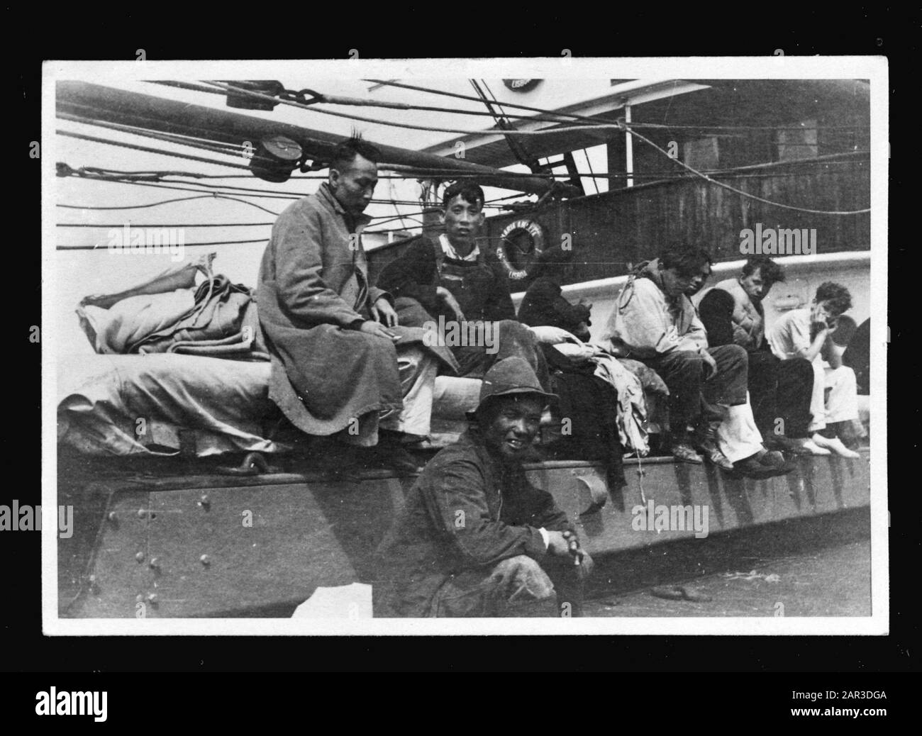 MN [Merchant Navy]/Anefo London Series Rescue at Sea [gerettete Männer asiatischer Herkunft] Anmerkung: Repronegativ. Der portugiesische Frachter S. Maria Amelia holt die Schiffswracks vom Frachtschiff S. 'Polyphemus' (1930) der Nederlandsche Steamvaart Maatschappij 'Ocean' ab, nachdem das Schiff auf dem Weg von Sydney nach England (über den Panamakanal) unter Kapitän C. Koningstein Wurde um 468 Meilen von New York durch das deutsche U-Boot "U 578" torpediert. Dabei kamen 15 Menschen an Bord ums Leben. Datum: 26.Mai 1942 Ort: Großbritannien Schlagwörter: Ertrunken, Handelsflotten, Marine, Schiffe, Weltkrieg Stockfoto