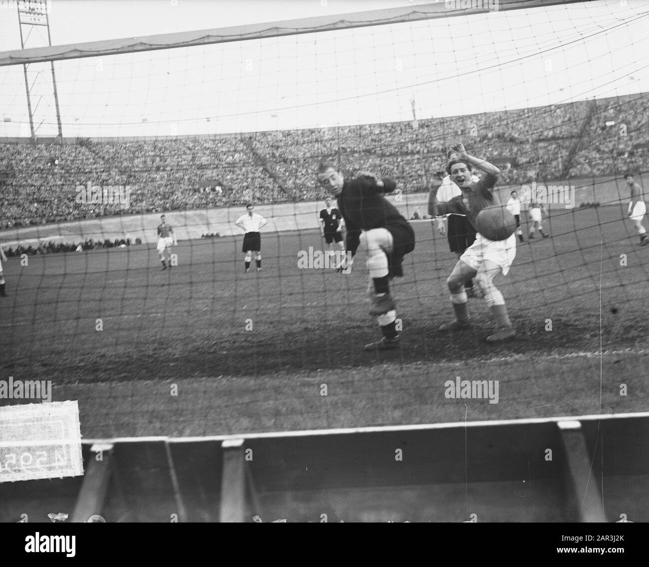 Fußball. Bondselftal gegen Derby County (1:1) im Olympiastadion Anmerkung: Das Glücksziel, mit dem die provisorische niederländische Mannschaft drei Minuten vor der Pause in der Partie gegen Derby County die Führung übernahm. Der englische Torhüter sieht schuldig aus, weil er den Eckstoß von Kokkie v. d. Gegeben hat. Tuyn, der ins Ziel sprengte, ein verhängnisvoller Vorstoß in die falsche Richtung, während Van Melis seine Freude über den Windfall nicht verheimlicht. Datum: 30.Mai 1951 Ort: Amsterdam Schlagwörter: Fußball Stockfoto