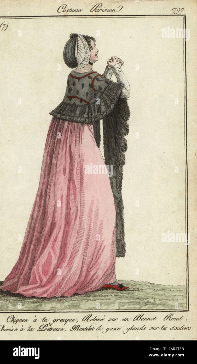 Sie trägt einen Bun im griechischen Stil, der in einer runden Motorhaube aufgerichtet ist, ein Kleid im Stil der Preißlosigkeit, einen Mullmantel und Hausschuhe mit Tasseln. Chinon a la grecque. Releve sur un bonnet rond. Chemise a la Praitresse. Mantelet du gaze, Drüsen sure les souliers. Handfarbige Kupferstichgravur von Pierre de la Mesangere's Journal des Modes et Dames, Paris, 1796. Die Illustrationen in Band 1 stammen von Carle Vernet, Claude Louis Desrais und Philibert Louis Debucourt. Stockfoto