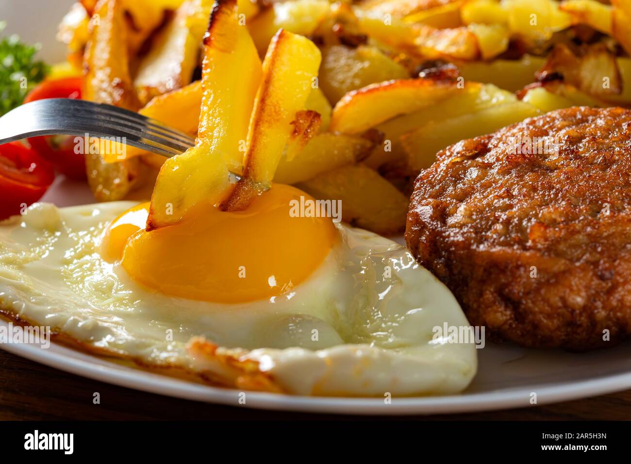 Pommes mit frittiertem Ei essen - Nahansicht Stockfoto