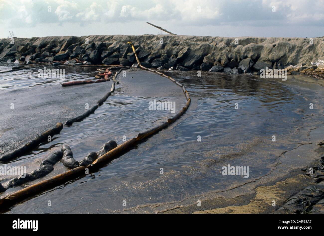 Mehrere Ausleger werden verwendet, um die Ölverschmutzung durch einen Tankerausstoß am Huntington Beach, CA, zu kontrollieren. Stockfoto Mehrere Ausleger werden verwendet, um die Ölverschmutzung durch einen Tankerausstoß am Huntington Beach, CA, zu kontrollieren. Stockfoto