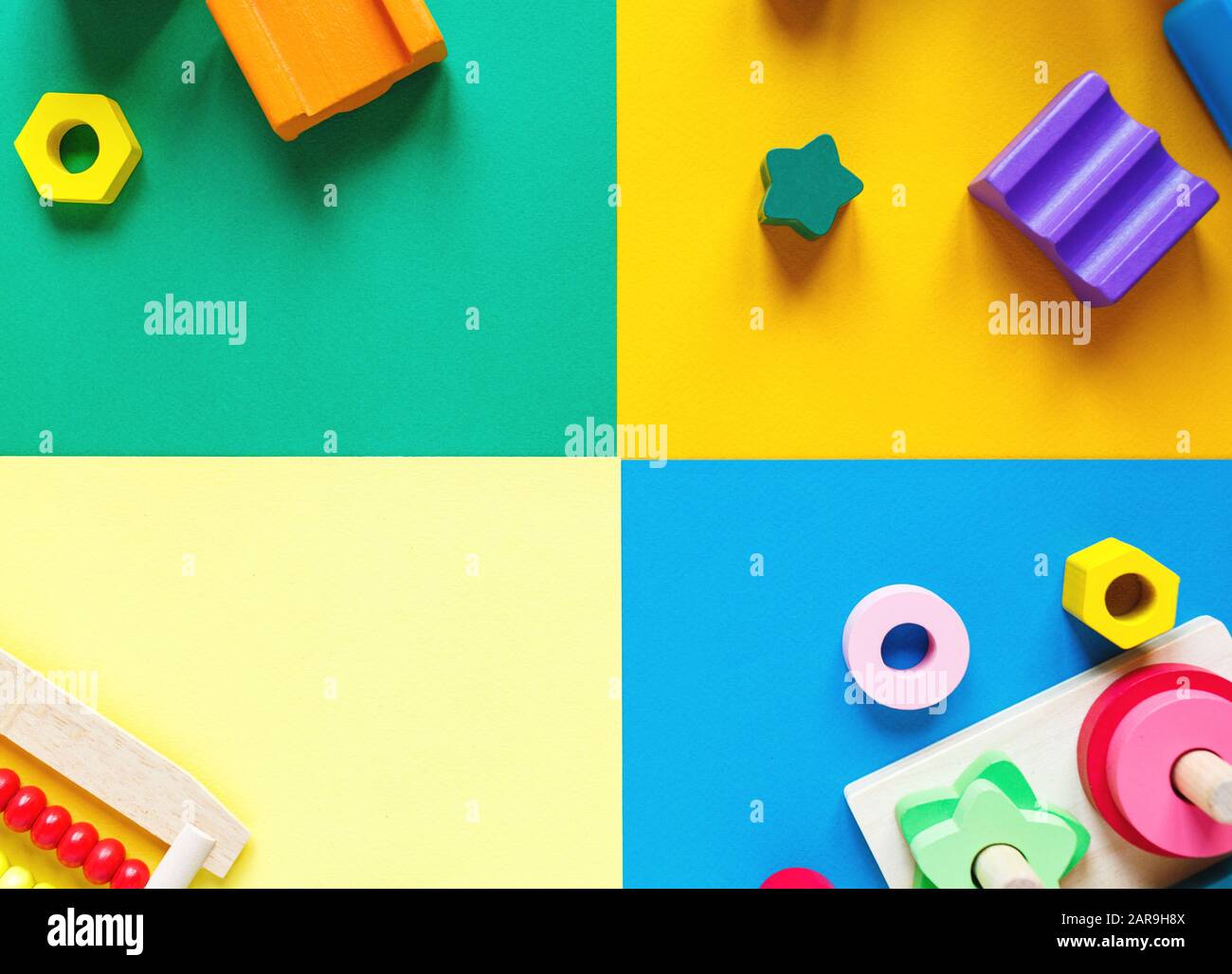 Holzspielzeug für Kinder auf farbenfrohem Papier. Spielzeugblöcke für Bildungseinrichtungen. Spielzeug für Kindergarten, Vorschule oder Kindertagesstätte. Platz für Text kopieren. Draufsicht Stockfoto