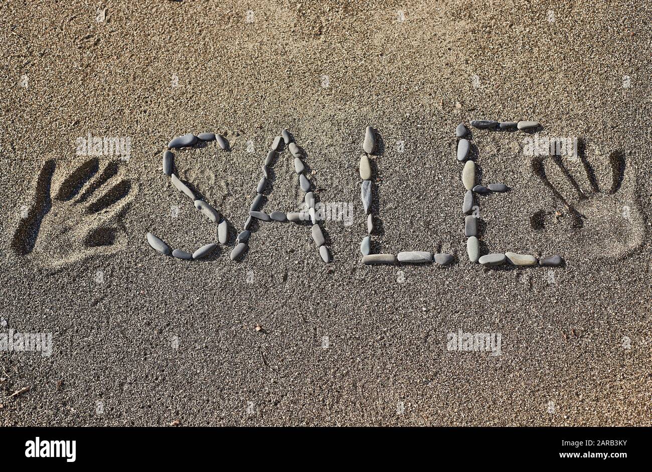 Das Wort Verkauf auf dem Sand Stockfoto