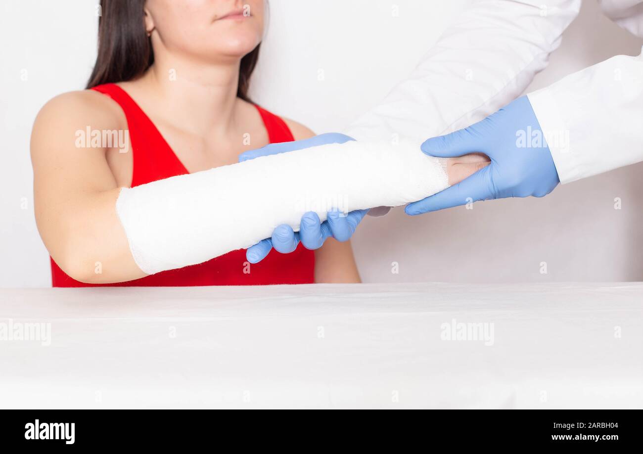Der Traumatologe untersucht die Hand einer jungen Patientin, die einen Bruch des Radius im Arm hat, die medizinische, extraartikuläre Fraktur Stockfoto