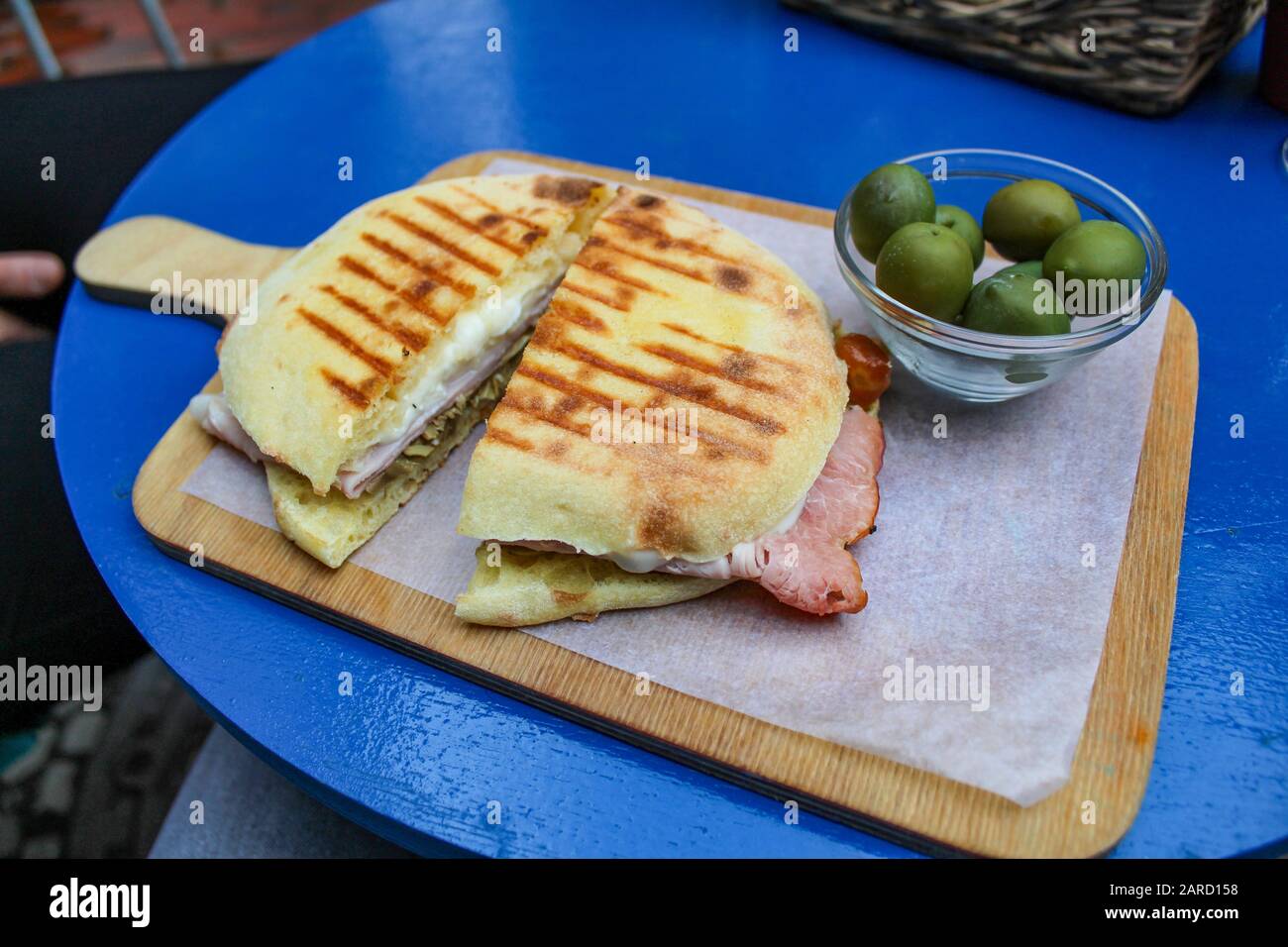 Italienisches Panino auf Holzbrett mit Oliven Stockfoto