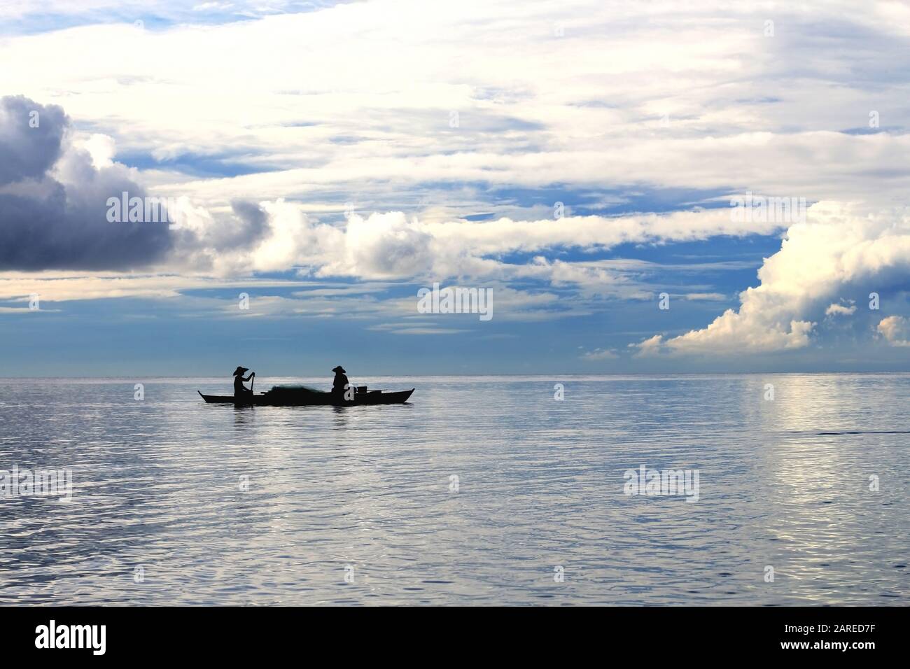 Minimalistisches Seascape, Silhouette zweier Fischer, tropische Insel Philippinen, konzeptioneller Hintergrund Stockfoto