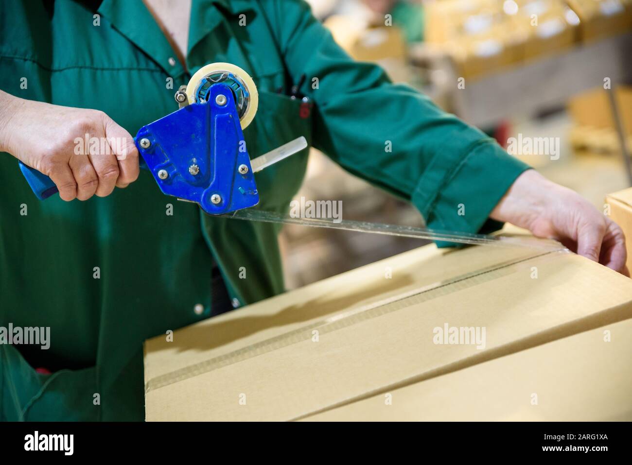 Verpackungsbandpistole auf einem Karton Stockfoto