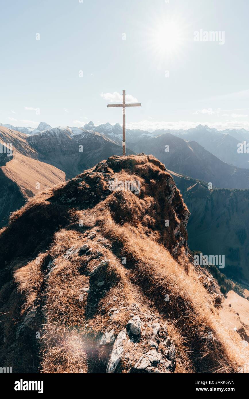 Gipfel mit Kreuz in den deutschen Alpen gegen blauen Himmel Stockfoto