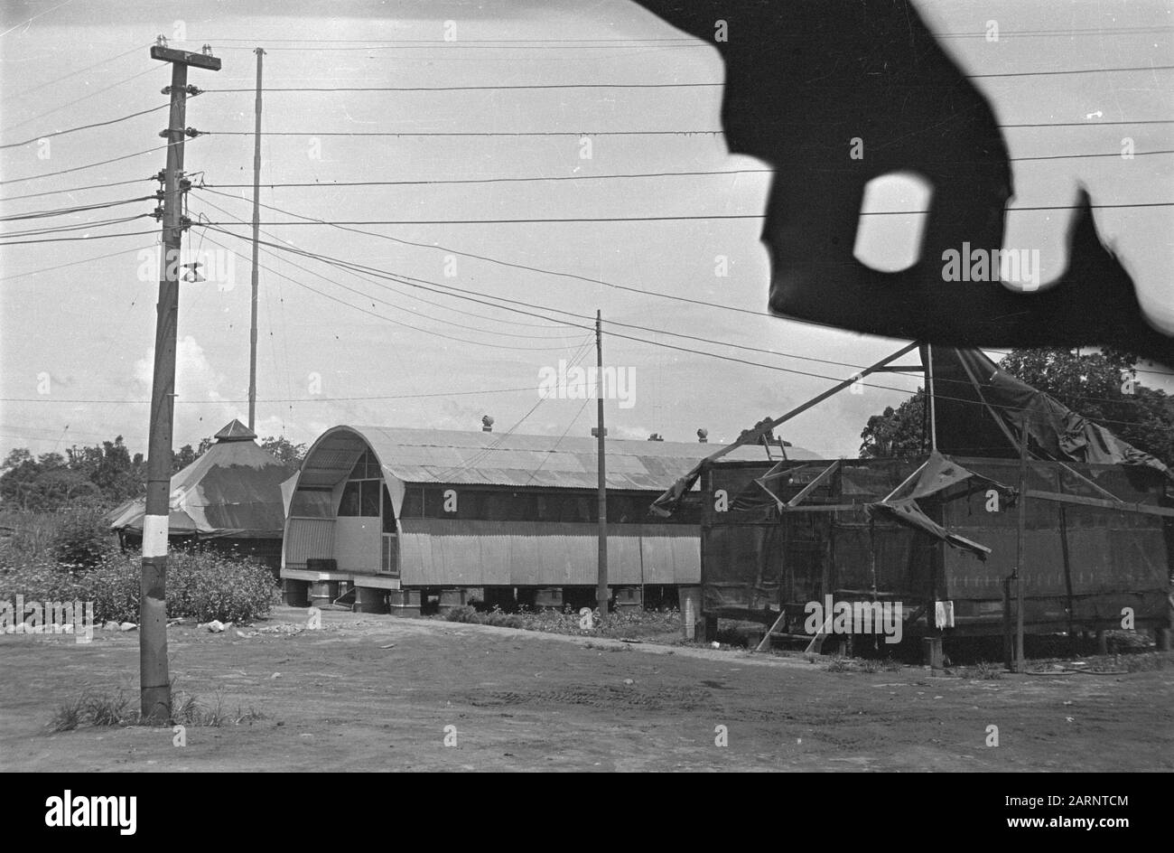 Luftwaffenstützpunkte Zwei teilweise zerstörte Gebäude mit einem Quonset Shed zwischen Datum: April 1947 Standort: Indonesien, Niederländisch-Ostindien Stockfoto