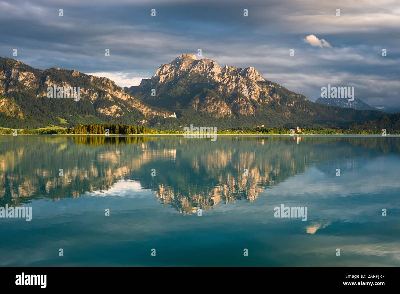 Schloss Neuschwanstein, Schloss Hohenschwangau und die bayerischen Alpen bei Sonnenuntergang spiegeln sich im Forggensee in Bayern wider Stockfoto