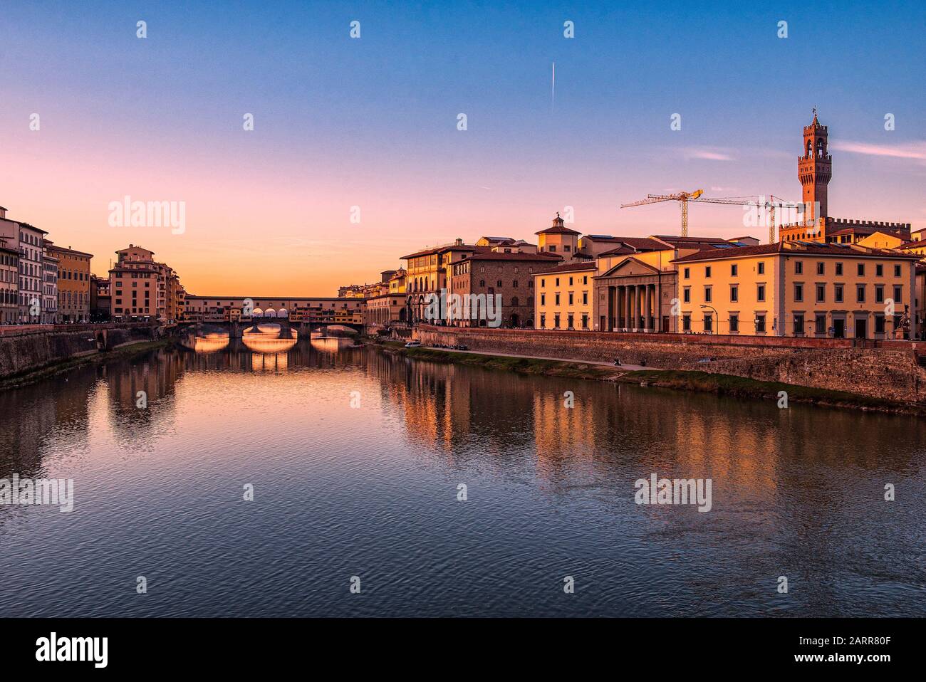 Firenze, Toskana, Italien. Postkartenbild bei Sonnenuntergang von Florenz. Der Arno-Fluss, die Ponte Vecchio und links der Palazzo Vecchio Stockfoto