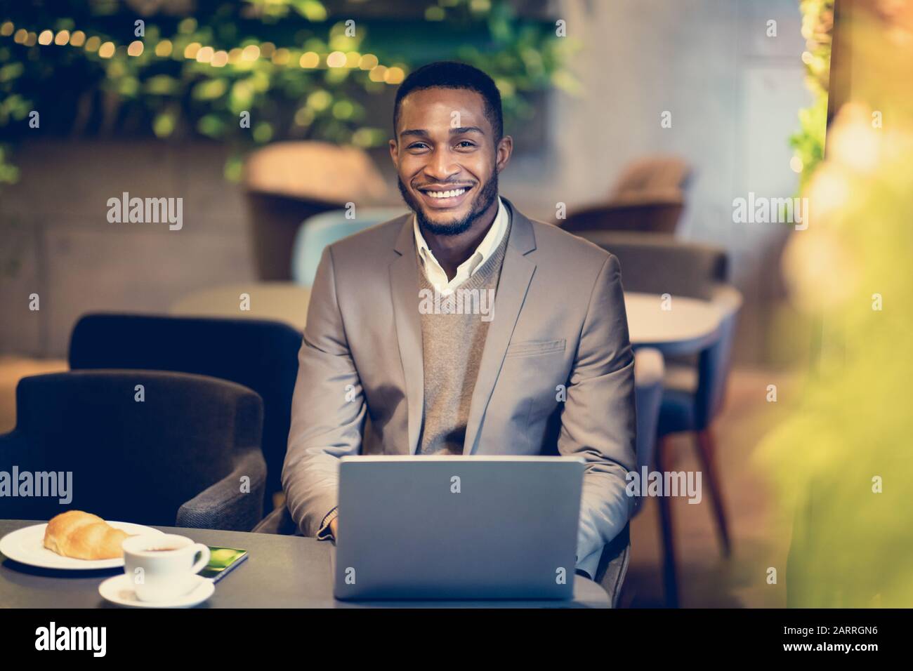 Portrait von gutaussehenden Afro Kerl, der die Kamera in der Bar betrachtet Stockfoto