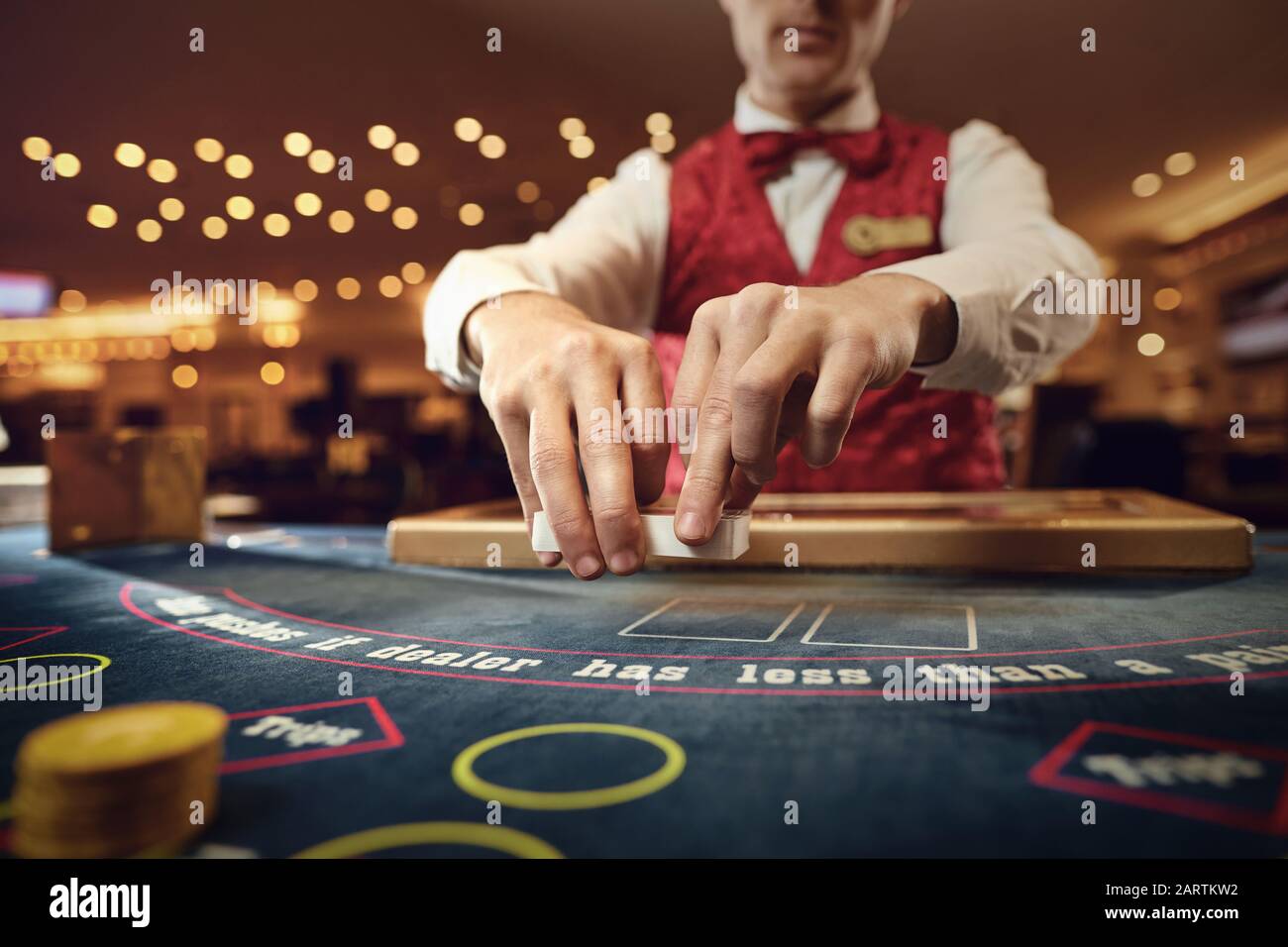 Croupier Poker Karten hält in seinen Händen an einem Tisch in einem Casino. Stockfoto