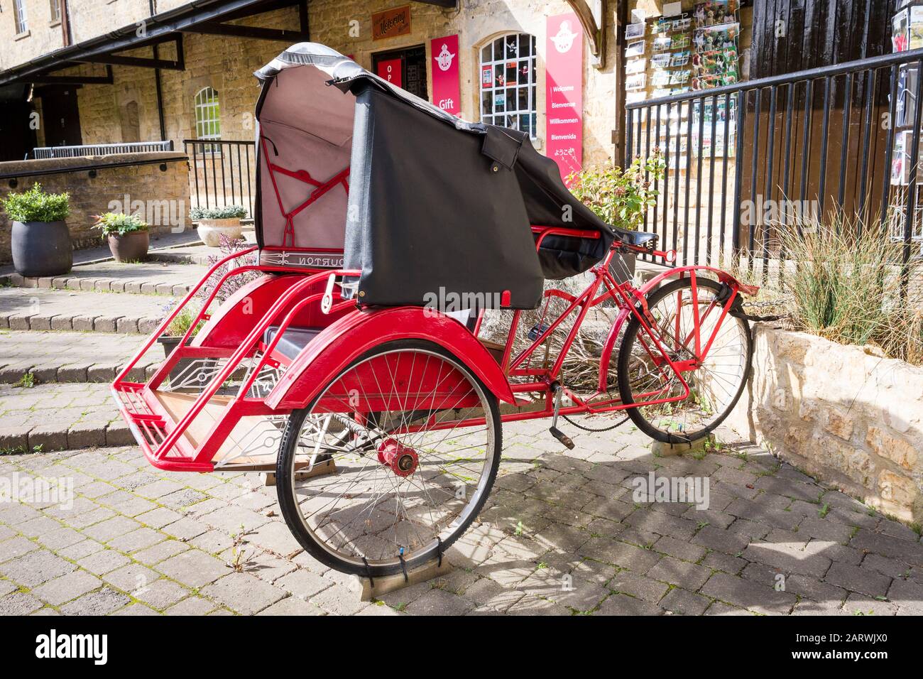 Pedalowered Dreiradtaxi im asiatischen Stil für zwei Passagiere, die im Motor Museum in Bourton auf dem Water England Großbritannien ausgestellt sind Stockfoto