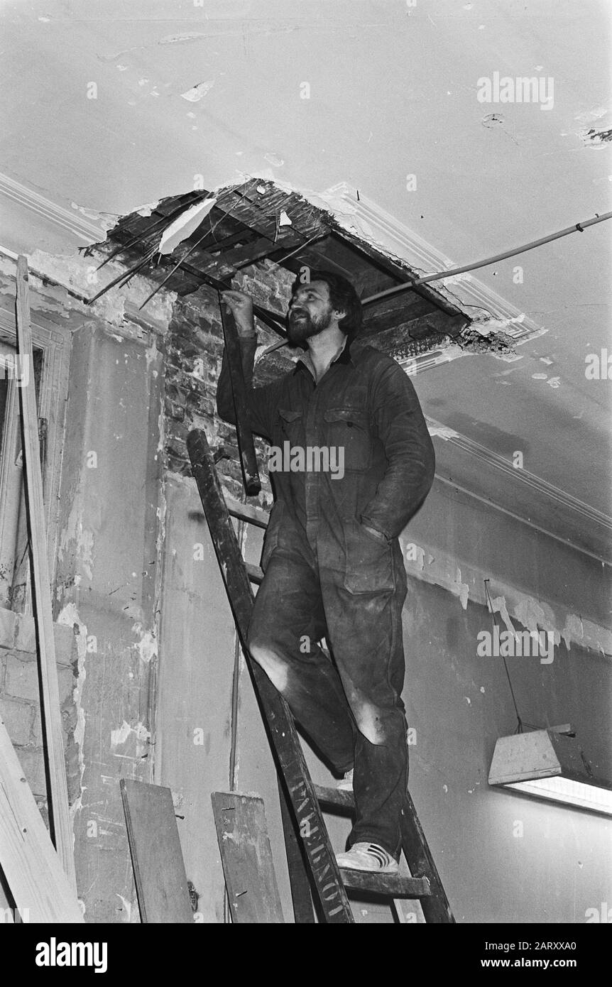 Zwischen der Decke des Gebäudes nach Amsterdamse Rokin, ein Arbeiter, der in das Loch der Decke blickt, wo das Zeug gefunden wurde Datum: 18. Februar 1981 Schlüsselwörter: Löcher, Decken, Objekte Stockfoto