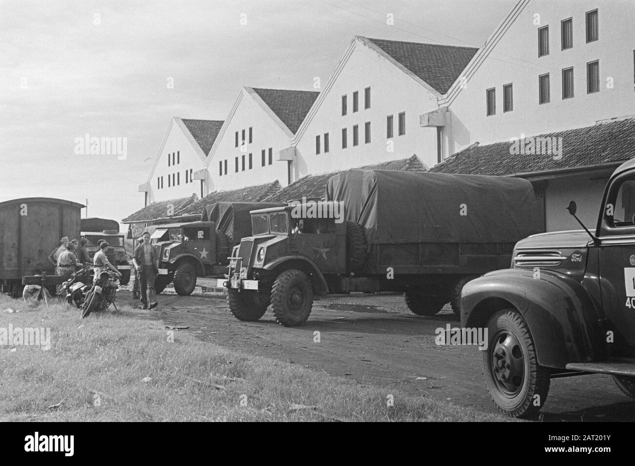 Lebensmittel-Goodsangs [Lagerhallen] des Generalquartiermeisters Exterior of the Good-angs. Vor LKWs und Zugwaggons Datum: März 1947 Standort: Batavia, Indonesien, Jakarta, Niederländisch-Ostindien Stockfoto