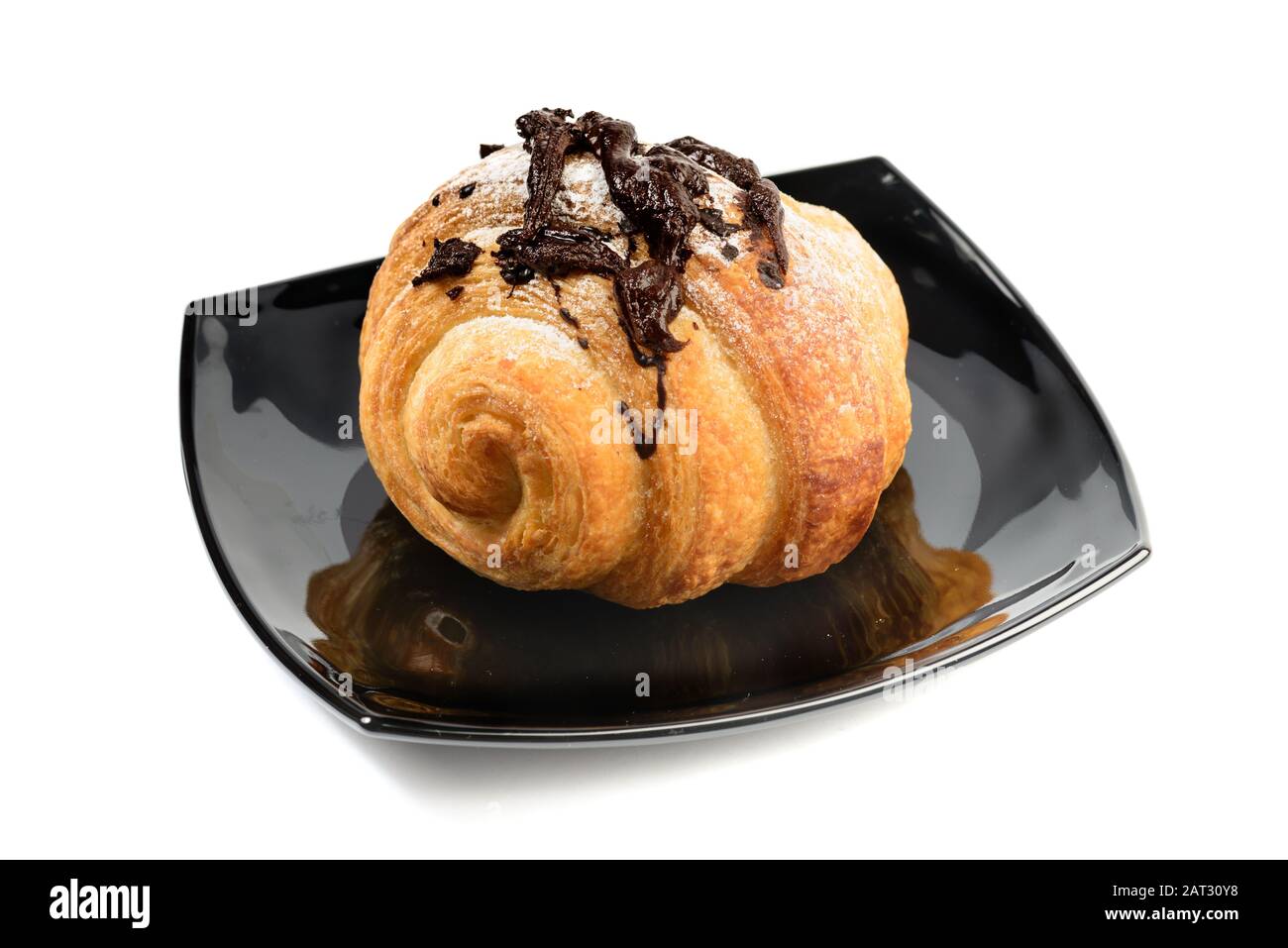 Französisches Croissant mit Schokolade auf schwarzem Teller isoliert auf weißem Hintergrund Stockfoto