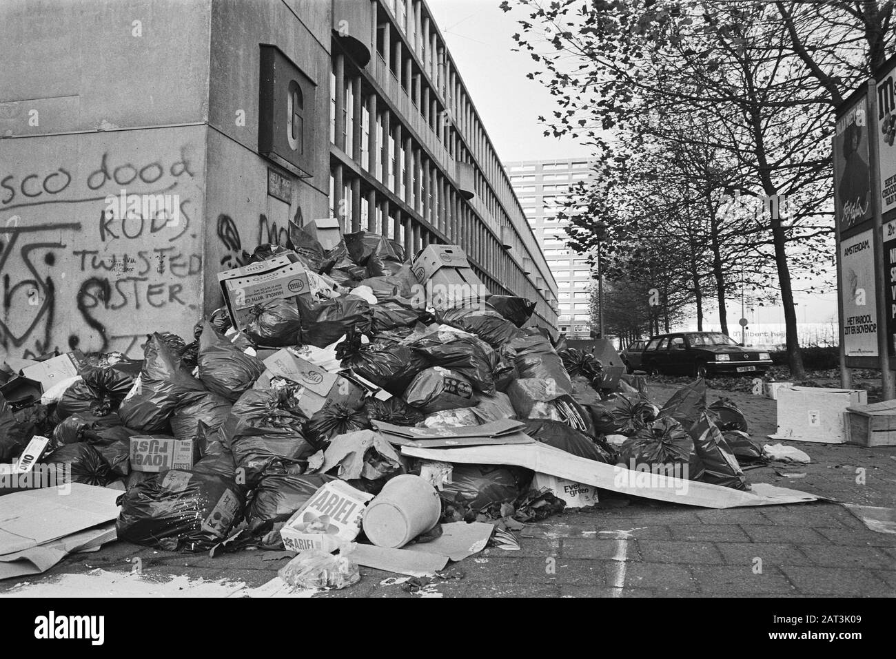Hohe Müllsäcke in Amsterdam-Noord durch den Streik der Beamten gegen Rabatte auf Gehälter; im Hintergrund ein Muiur mit Graffiti Datum: 14. November 1983 Ort: Amsterdam, Noord-Holland Schlüsselwörter: Abfall, Beamte, Graffiti, Streiks Stockfoto