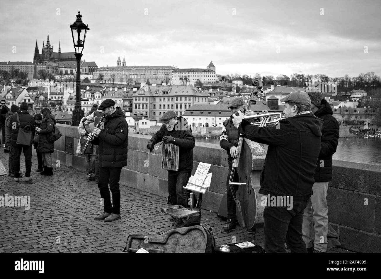 Prag, Tschechien - 01. Januar 2020: Straßenmusiker spielen auf der Karlsbrücke in der Nähe eines Lampenpostens Musik Stockfoto