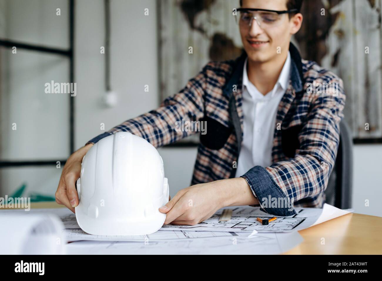 Ingenieur mit hartem Hut in den Händen, arbeitet im Büro Stockfoto