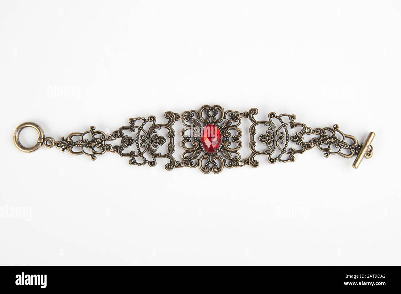 Boho Armband Schmuck Ruby Edelstein mit Metallic-Vintage-aufwändigem Design. Modezubehör ist auf einem hellen Hintergrund isoliert. Stockfoto
