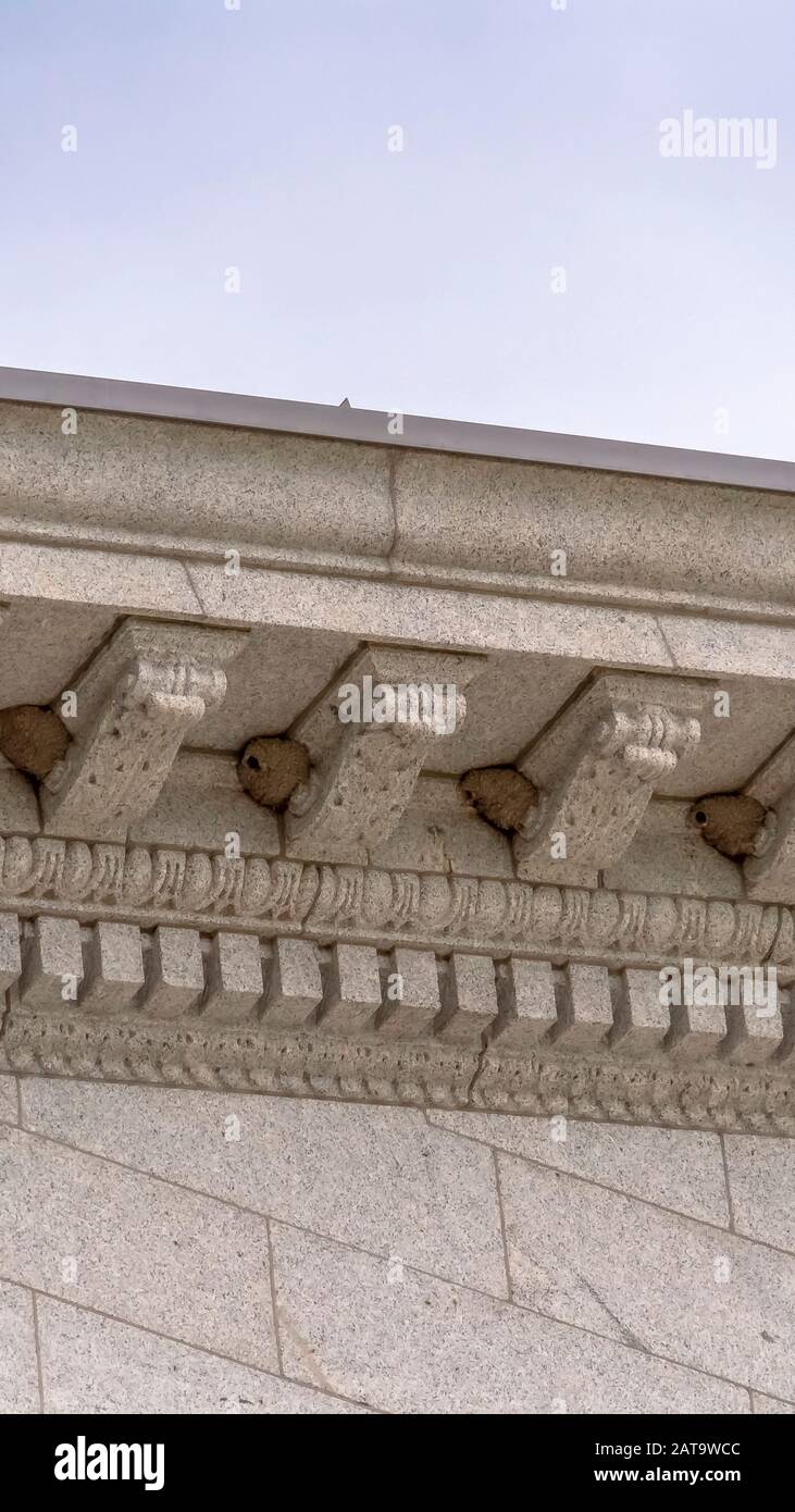 Vertikale Rahmen Bienenstöcke auf der Außenseite Steinwand mit dekorativen Leisten eines Gebäudes Stockfoto