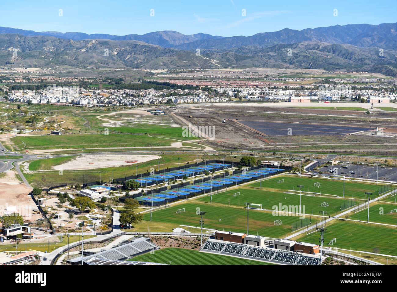 Irvine, KALIFORNIEN - 31. JANUAR 2020: Luftbild der Tennisanlage, Fußballfelder mit neuen Häusern und die santa Ana Mountains in der Ferne. Stockfoto