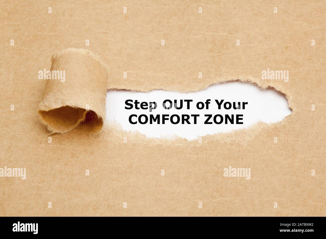 Motivierendes Angebot: Verlassen Sie Ihre Komfortzone. Hinter geripptem braunem Papier. Stockfoto